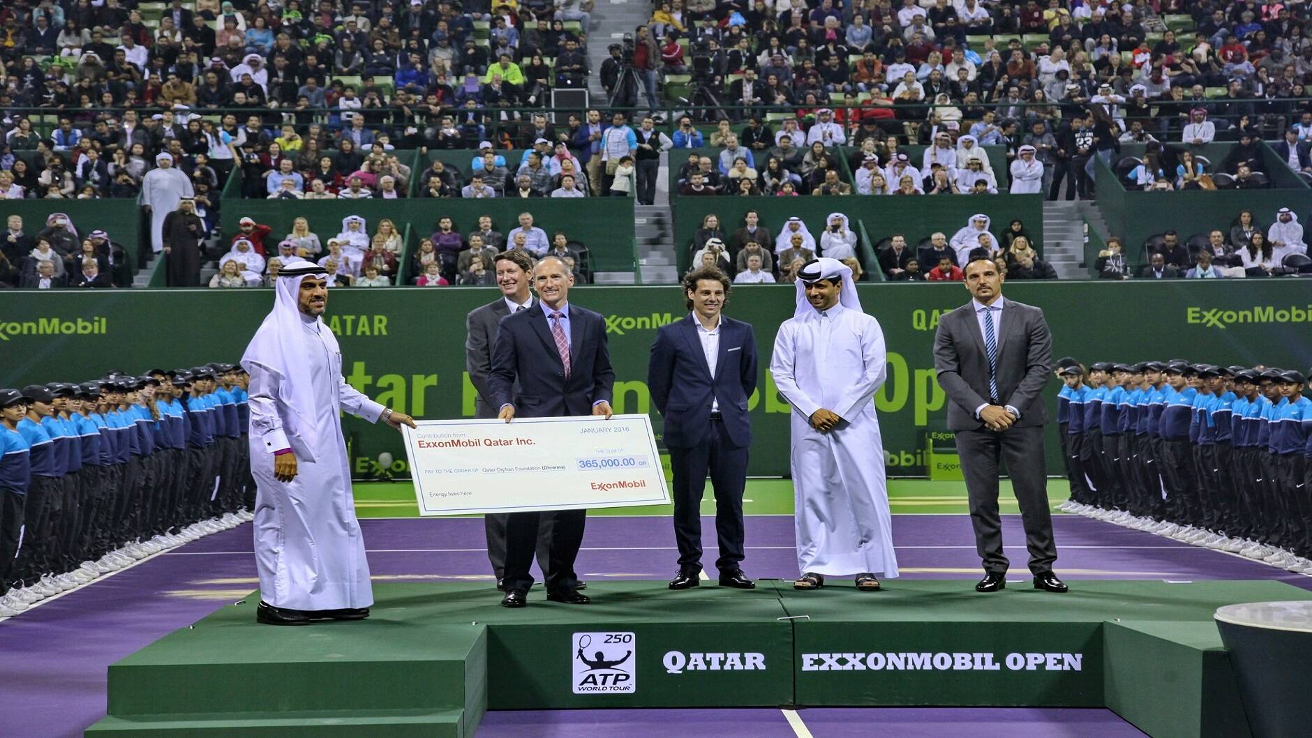 During the 2016 closing ceremony, Alistair Routledge, President and General Manager for ExxonMobil Qatar, presented a check to Issa Salman Al Kuwari, Deputy General Manager for Dhreima, to support the Orphans Care Center Qatar (Dhreima).